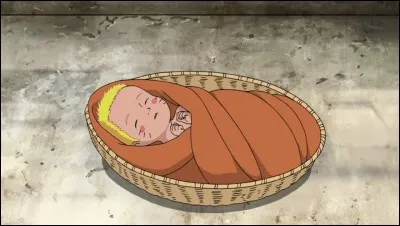 Who was the first person to hold Naruto when he was born?