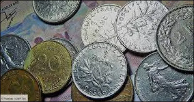 Which government decided to devalue the franc by 80% in 1948?