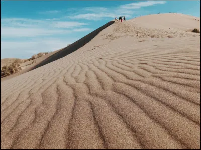 Which town in the Philippines has a beach with singing sand?