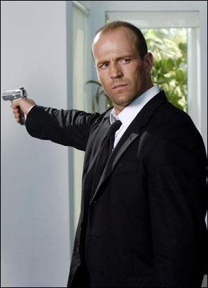 Jason Statham Holding a Gun in...