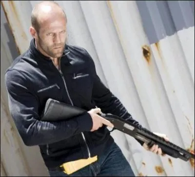 Jason Statham Holding a Gun in...