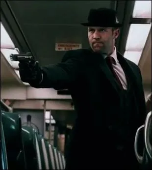 Jason Statham Holding a Gun in...