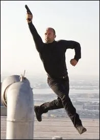 Jason Statham Holding a Gun and Running in...