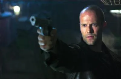 Jason Statham Holding a Gun in...