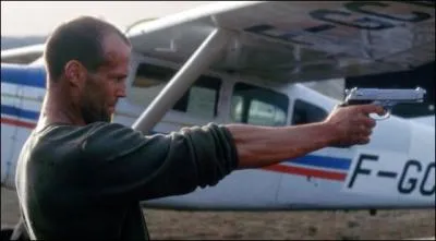 Jason Statham Holding a Gun in...