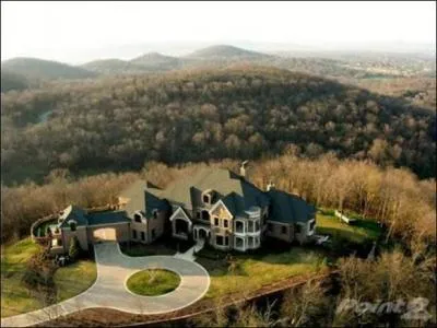 Whose home is located in Franklin Tenn? This home features a theater a wine cellar and a bar. This expansive property also includes a pool, hot tub and a guesthouse. This home is 13, 380 square feet.