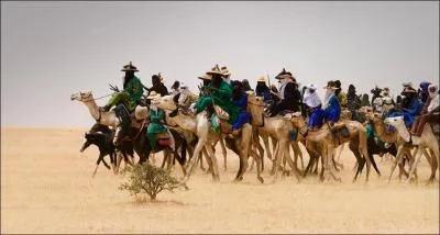 What do we call people that move from place to place with herds of animals to find pasture and water?