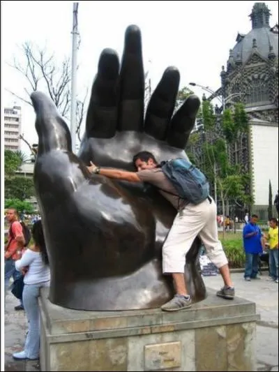 The man in this picture is hugging what type of artwork?