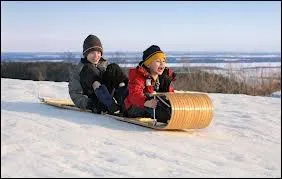 What do Canadians call a wooden sled that curves up at one end?