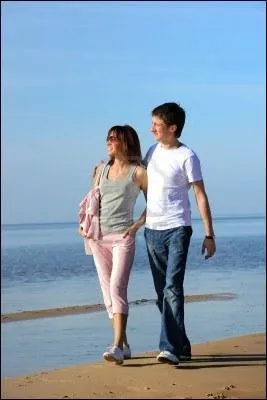 This is a photograph of my girl friend and ... walking along the shore.