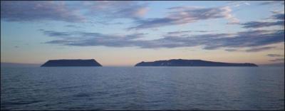 In the middle of the strait you can see two islands : ... Big Diomede and ... Little Diomede. They are separated by the International Date Line.