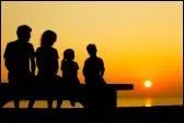 The children were sitting on a bench ... their parents, watching the sunset.