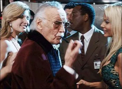 Stan Lee sitting at a party with some very pretty girls.