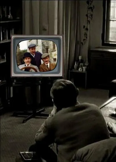 What is this man watching on television?