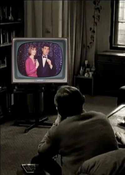 What is this man watching on TV?