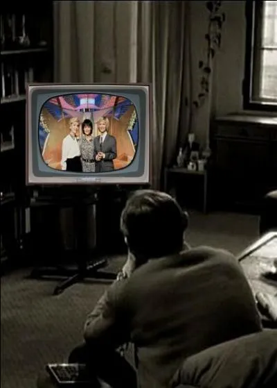 What is this man watching on TV?