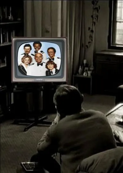 What is this man watching on television?