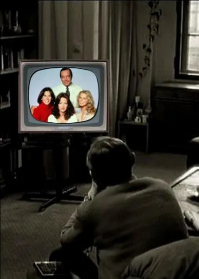 What is this man watching on television?